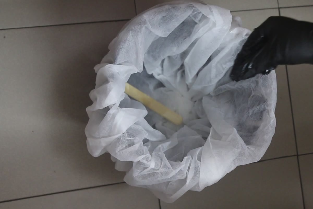 Fresh single-use wax strips in a lined bowl — hygiene protocol before an appointment