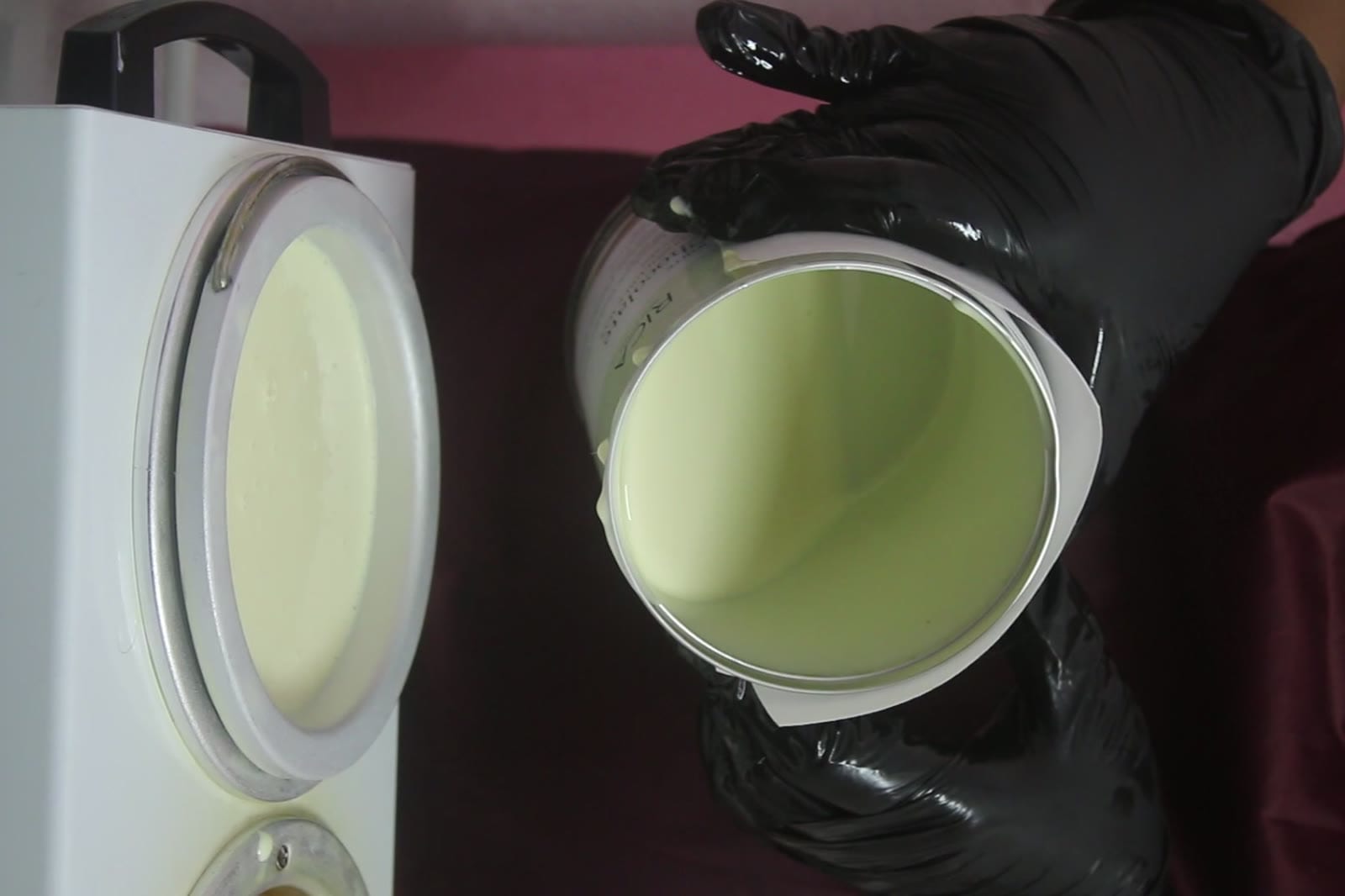 Waxing — Melted wax poured into a warmer during a professional waxing treatment