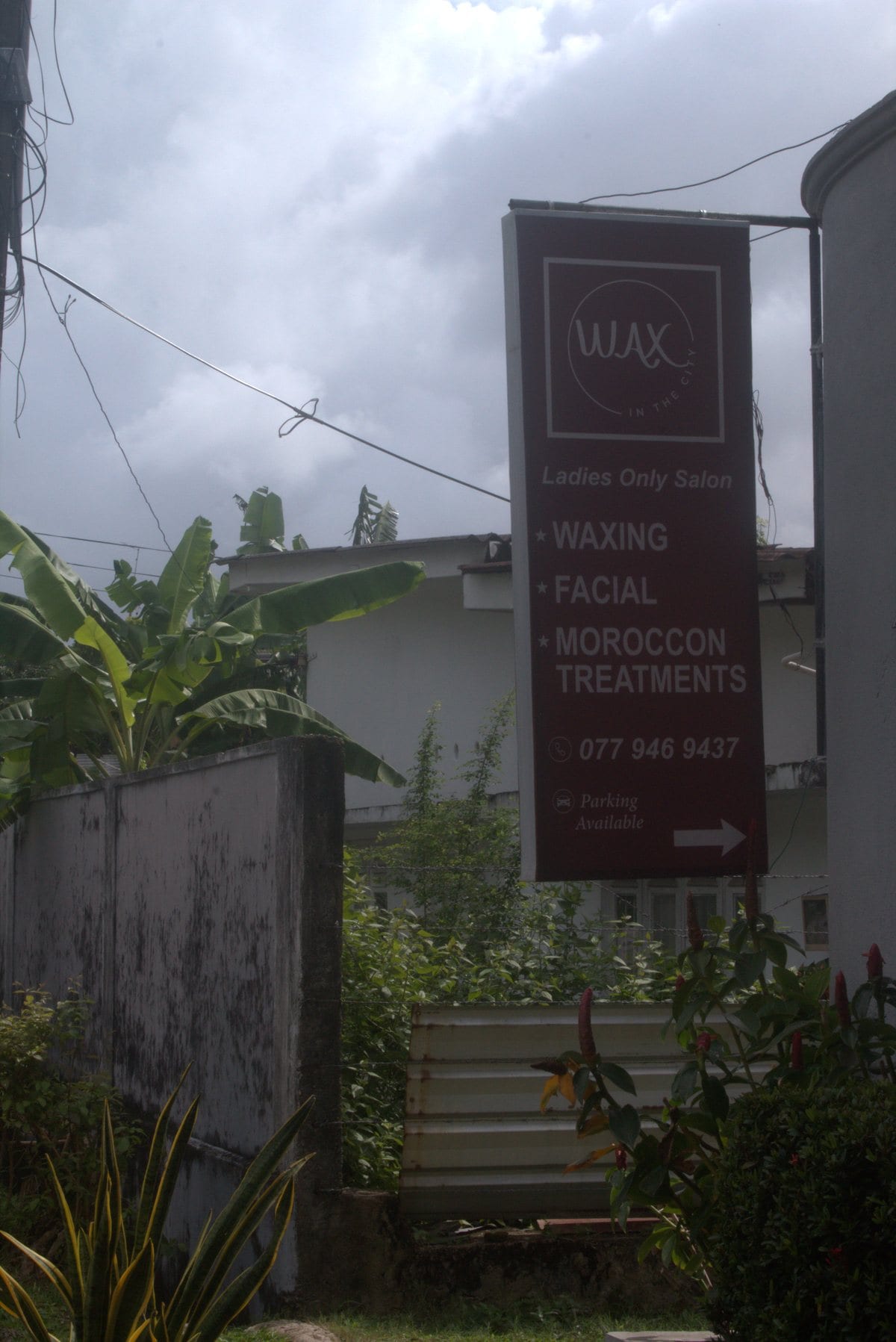 Wax In The City studio signage on a quiet Colombo street