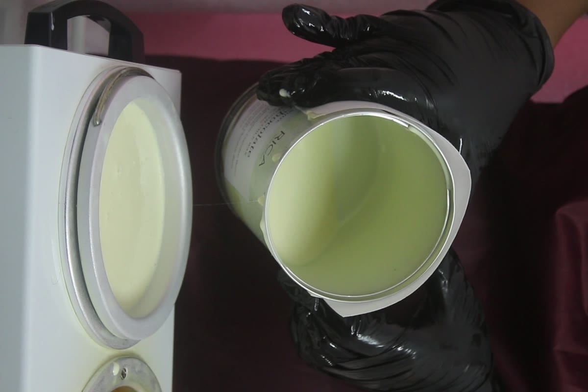 Melted RICA wax poured into the studio warmer — fresh wax prepared for every guest